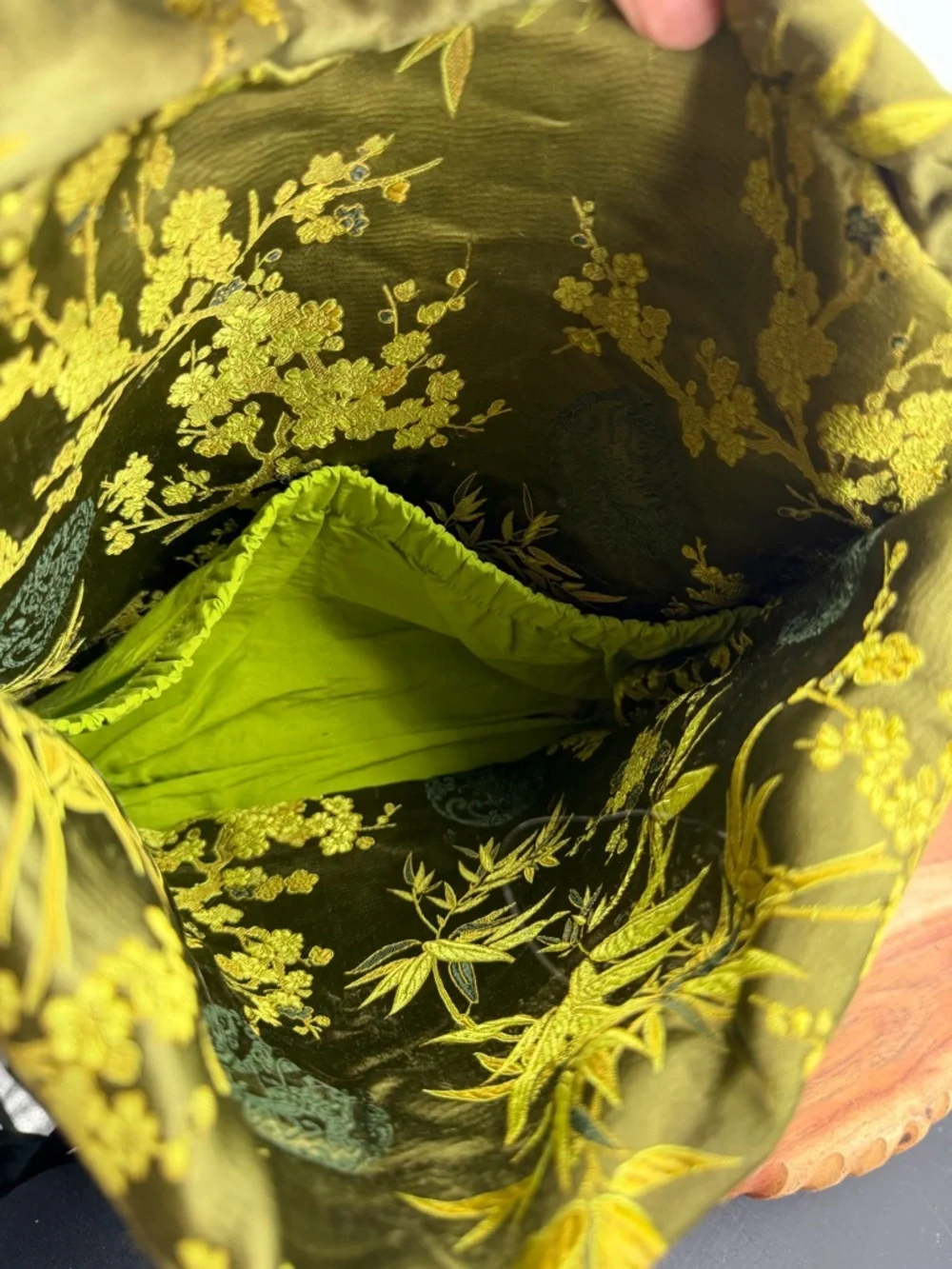 Petunia Pickle Bottom diaper bag in a green, silky, bamboo-themed fabric